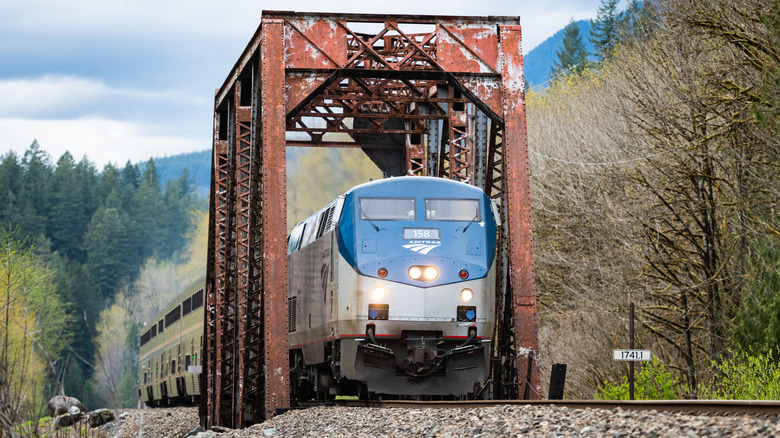 The Empire Builder trains chugs over a trestle bridge in the northwest.