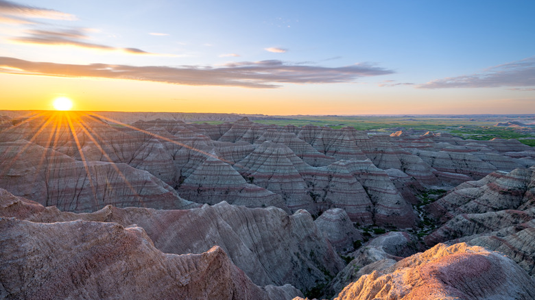 Vibrant sunrise over the beautiful geological rock formations around Big Badlands Overlook in Badlands National Park in South Dakota USA