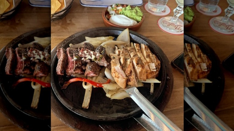 Steak and vegetable fajitas on a cast iron skillet