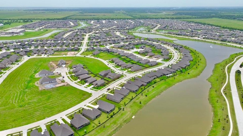 An areal view of a suburb development along a waterway in Iowa Colony, a community in Houston, Texas.
