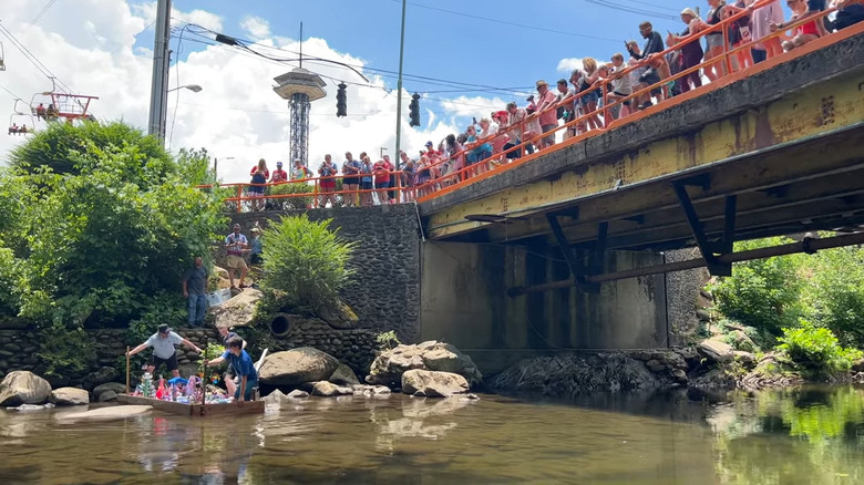 People watching a river raft race from a bridge in Gatlinburg