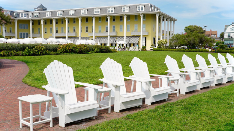 white lawn chairs lined up in front of a green lawn and Congress Hall building