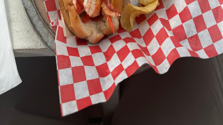 Lobster roll with potato chips at seaside shack in Maine
