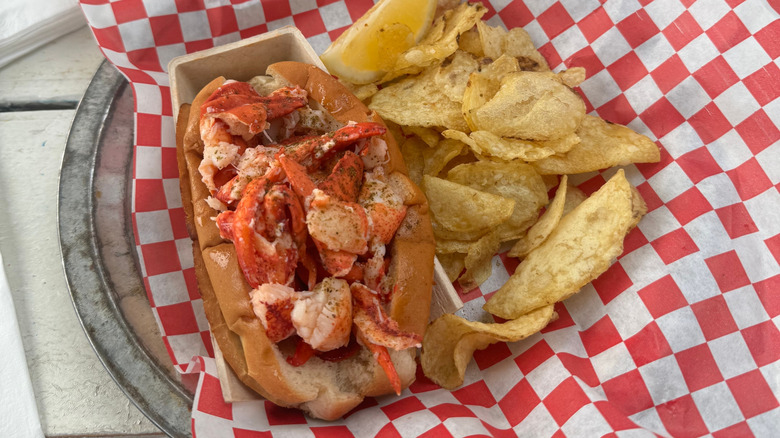 Lobster roll with potato chips at seaside shack in Maine