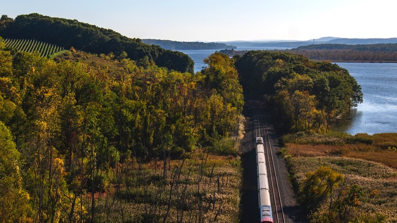 Amtrak train passing alongside Hudson River
