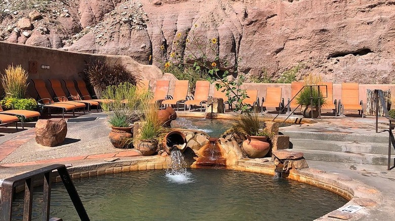 Red-rock cliffs surround pools