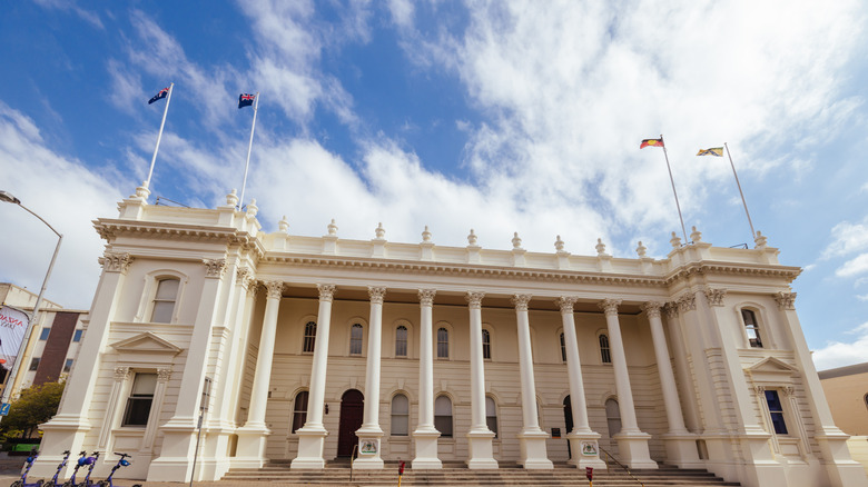 Launceston Town Hall, a historic neoclassical building with flags on the roof