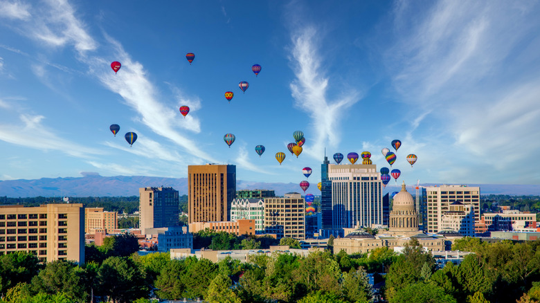 Hot air balloons floating over Boise, Idaho on a sunny day