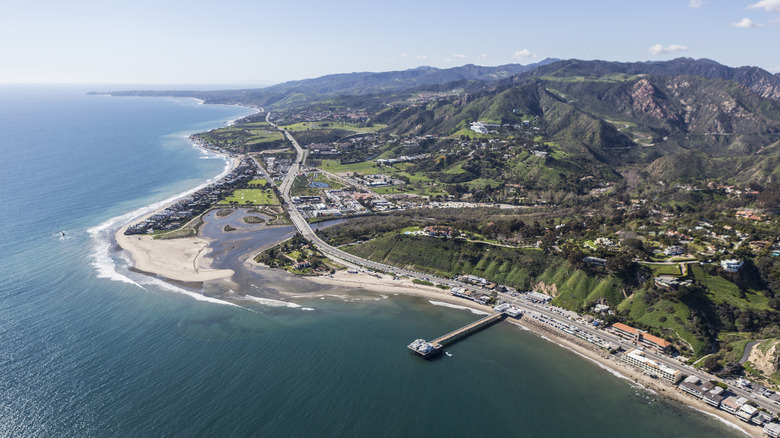 Aerial view of Surfrider Beach and Malibu Lagoon State Beach with Santa Monica Mountains in background