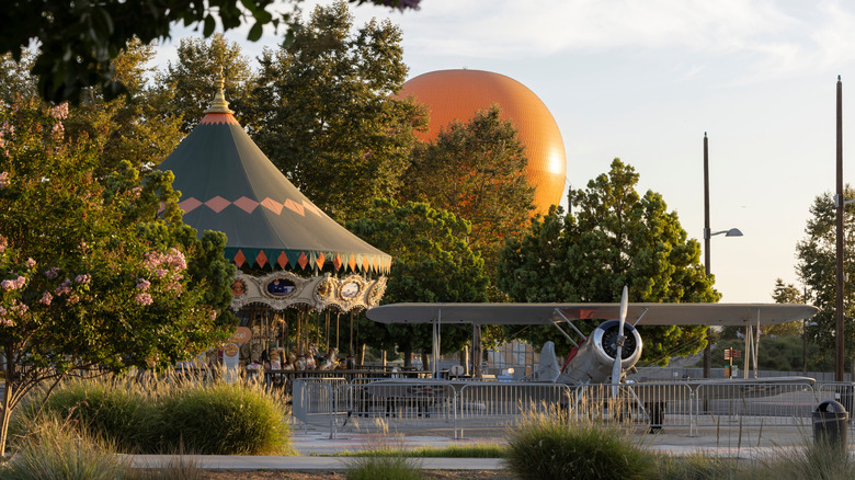 A carousel, small plane on display, and orange balloon at Great Park in Irvine, California