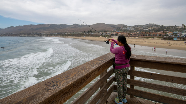 Girl fishing on Pismo Pier, California