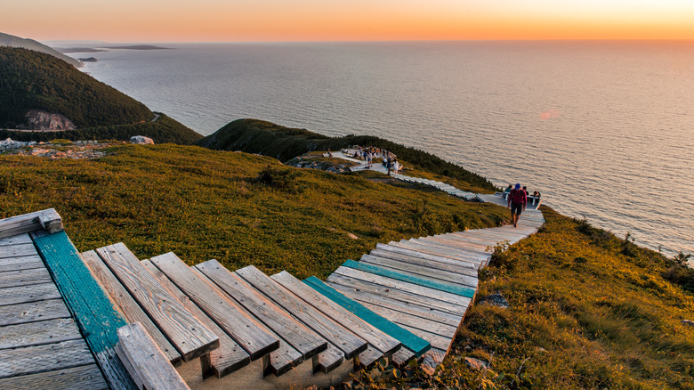 Hiking the scenic Skyline Trail at sunset, Cabot Trail at Cape Breton Highlands National Park, Nova Scotia, Canada. Boardwalk with wooden steps at headland