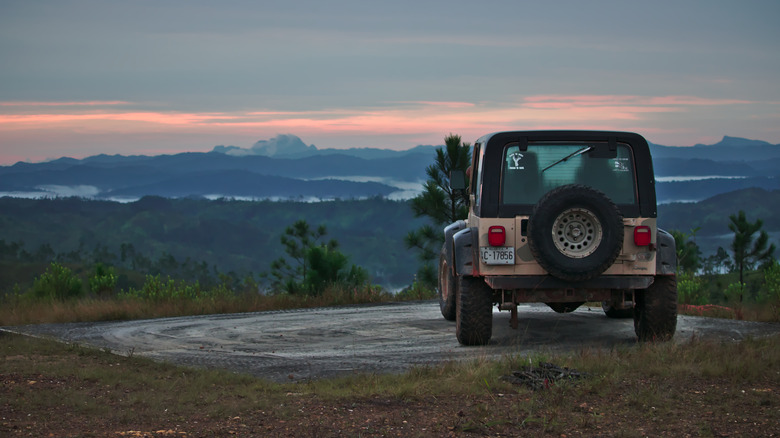 Jeep parked on a ridge overlooking Mountain Pine Ridge Forest