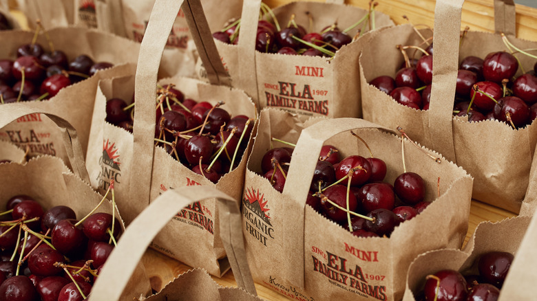 Organic cherries at a Farmer's market in brown paper bags