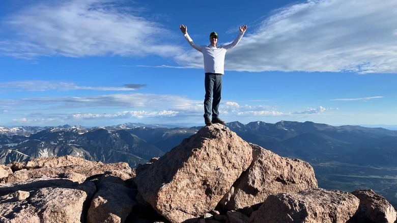 a man summiting Longs Peak in Colorado