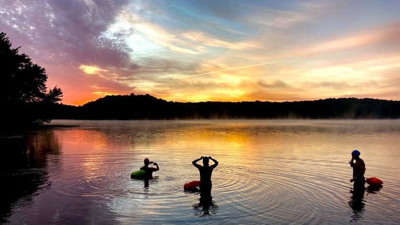 Swimmers take in the sunset at Powers Lake in Connecticut