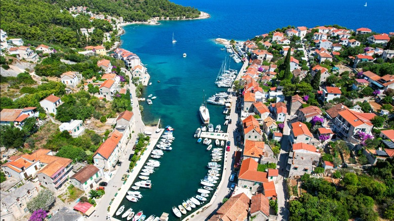 Marina and coastal town with tile orange roofs.