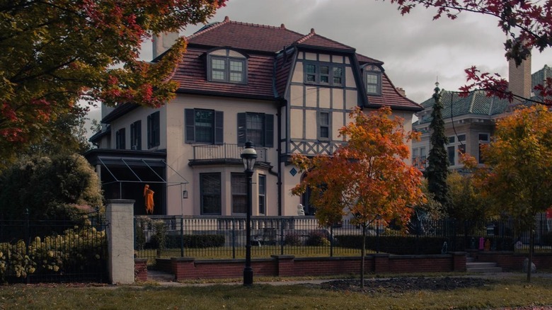 Red-roofed historic house in Indian Village with fall leaves