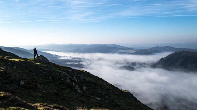 Hiker silhouette overlooking England's Lake District