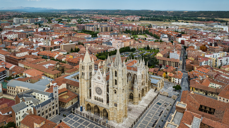 A grand cathedral surrounded by brick buildings in León, Spain