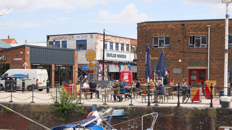 People dining at a waterfront restaurant in Hull