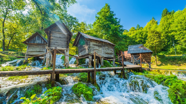 Old wooden mills stilted over a waterfall in Jajce, Bosnia and Herzegovina