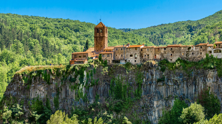 The village of Castellfollit de la Roca hangs from the edge of a volcanic cliff