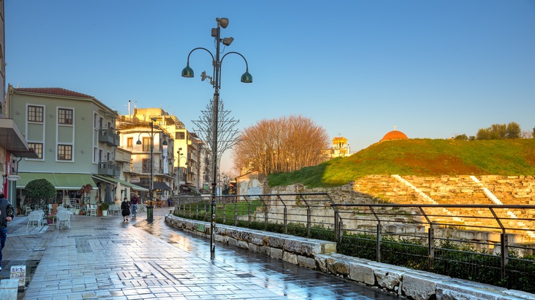 Peaceful pedestrian street near ruins at sunrise in Larissa, Greece