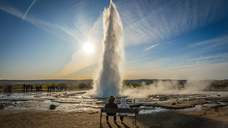 Strokkur Geyser eruptin in Iceland while people watch