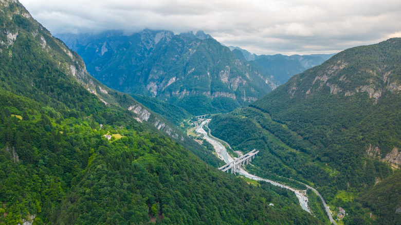 Mountains loom over a valley along the Alpe-Adria Trail