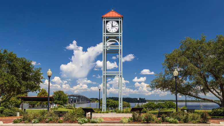 A clock tower by a river