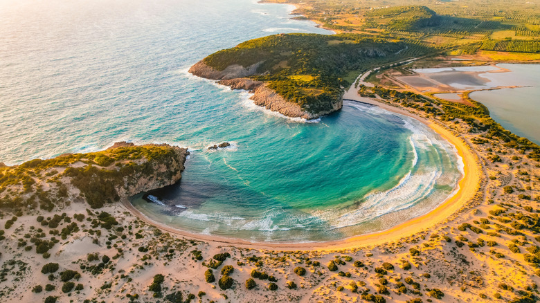looking down at Voidokilia Beach and U-shaped inlet from above