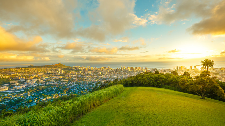 Tantalus Lookout at sunset, Puu Ualakaa State Park Honolulu. Tourists on panoramic city,Waikiki Beach and Diamond Head. Waikiki skyline Oahu Hawaii