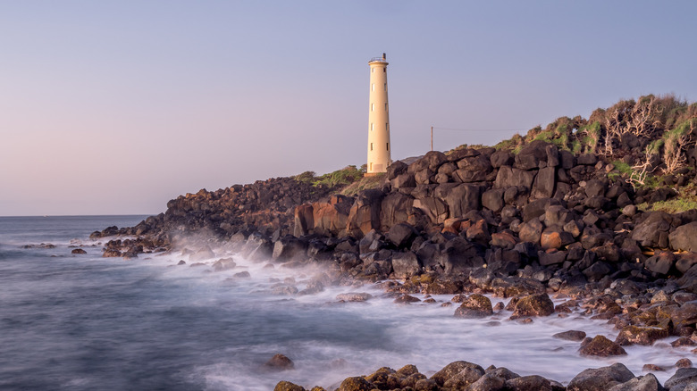 Ninini Point Lighthouse with foggy waves in Līhuʻe, Hawaii