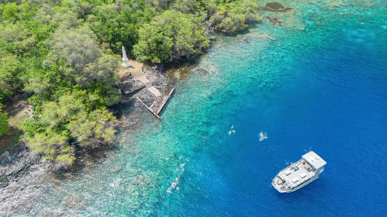 people swimming, boat on water, and Captain Cook monument, Kealakekua Bay, Big Island, Hawaii