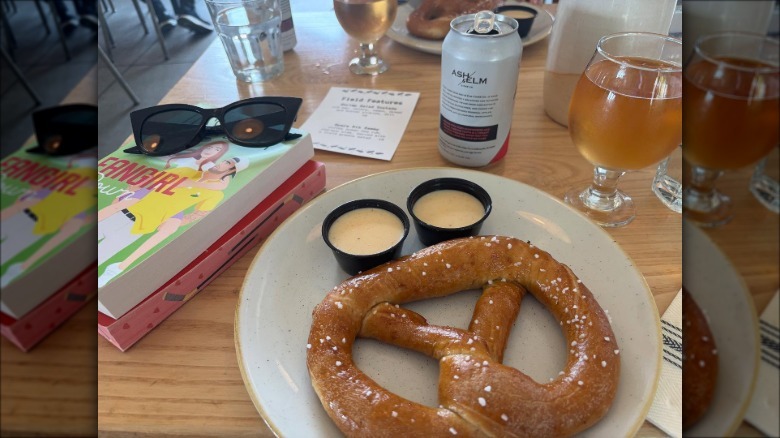 Large pretzel and a can of beer