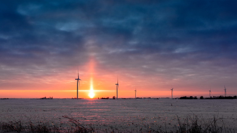 Sun setting in front of wind turbines in Marshalltown, Iowa