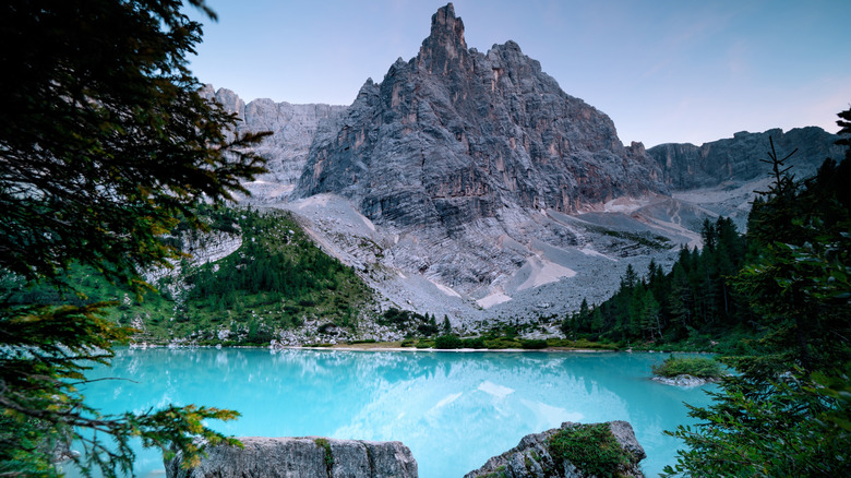 A gleaming turquoise lake surrounded by jagged mountains