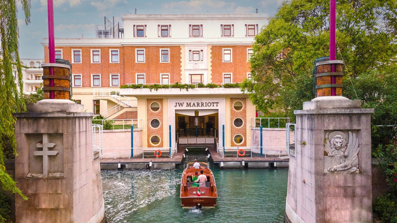 A boat takes two guests through the Venetian lagoon to check-in at the front desk of the JW Marriott Venice Resort & Spa, located on the private island of Isola delle Rose, about 20 minutes from St. Mark's Square in Venice