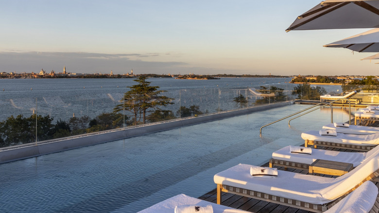 View of the Venice cityscape from the fourth-floor rooftop pool at JW Marriott Venice Resort & Spa, located on the private island of Isola delle Rose, photographed around sunset