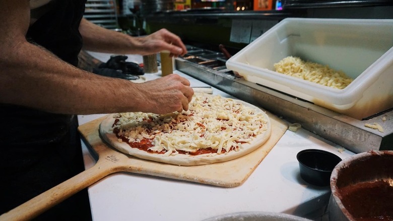 Man at Moon River Pizza preparing pizza