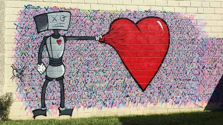 Mural on wall depicting robot holding heart