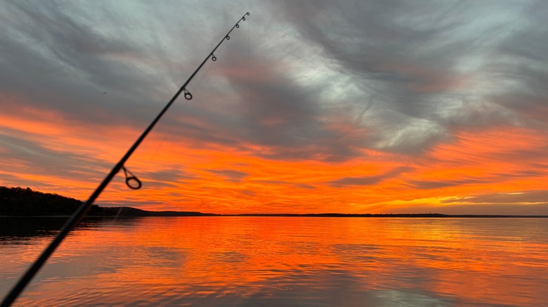 Fishing with sunset reflected in the water on Clinton Lake
