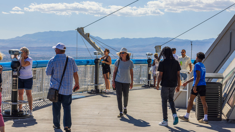Tourists take in the views from the outdoor observation deck at The Strat