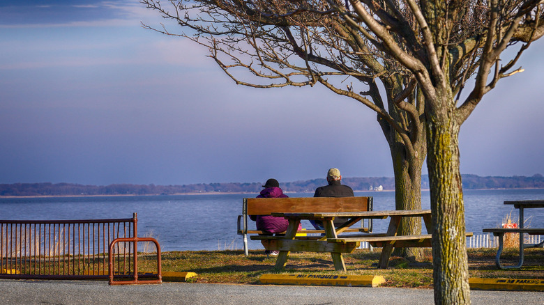 Couple on a bench in a park in Crownsville, MD