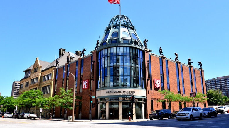 Large building with round windows and red flag, Grohmann Museum