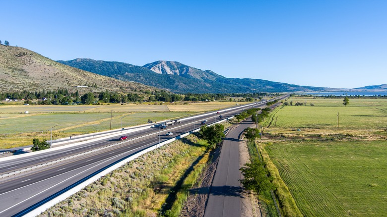 a road leading through Washoe Valley with mountains in background