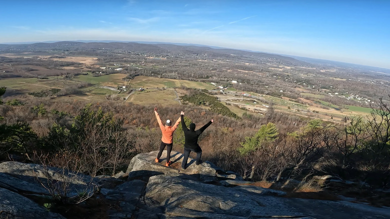Two people standing on rocks on Stairway to Heaven vista