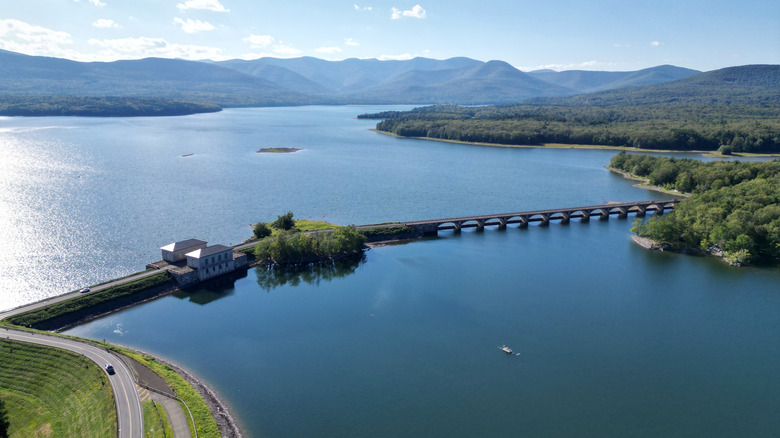 Aerial view of Ashokan Reservoir, a dam, and rolling hills