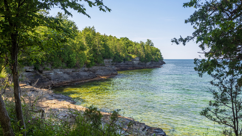 cliffs and green vegetation on a lakeside
